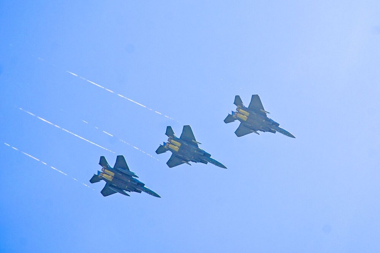 Military jets train, roar over outdoor graduation